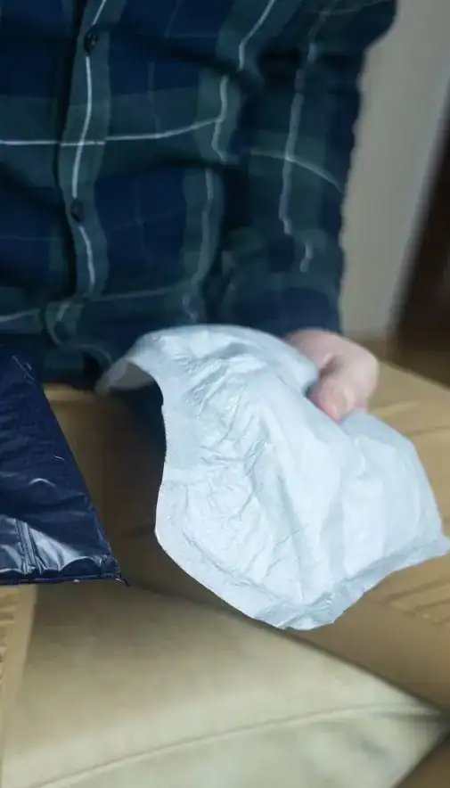 Image of man holding incontinence pads as part of overactive bladder treatment Kingston Upon Thames