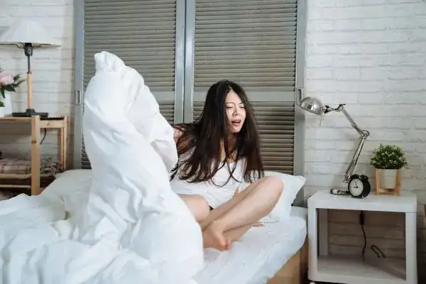 Image of woman getting up because of nighttime leaks Kingston Upon Thames